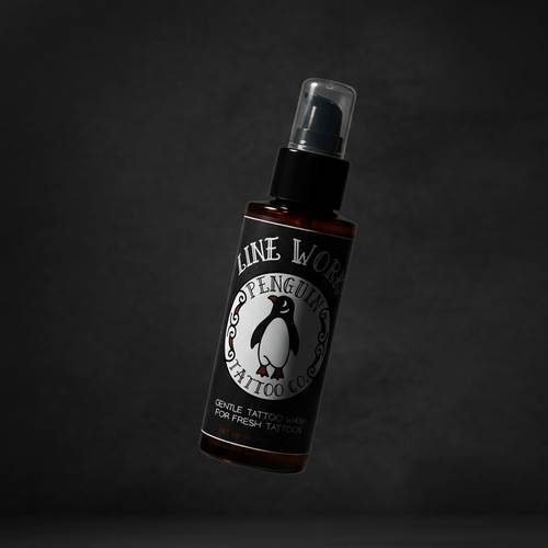 Bottle of Line Work Tattoo products on a dark background
